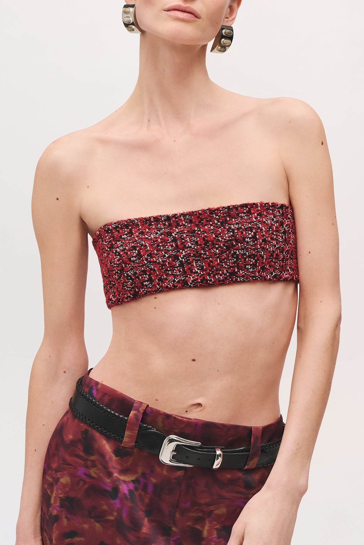 Close-up front view of a model wearing the Demi Bandeau in Red Static, highlighting the strapless neckline and red-and-black pattern.