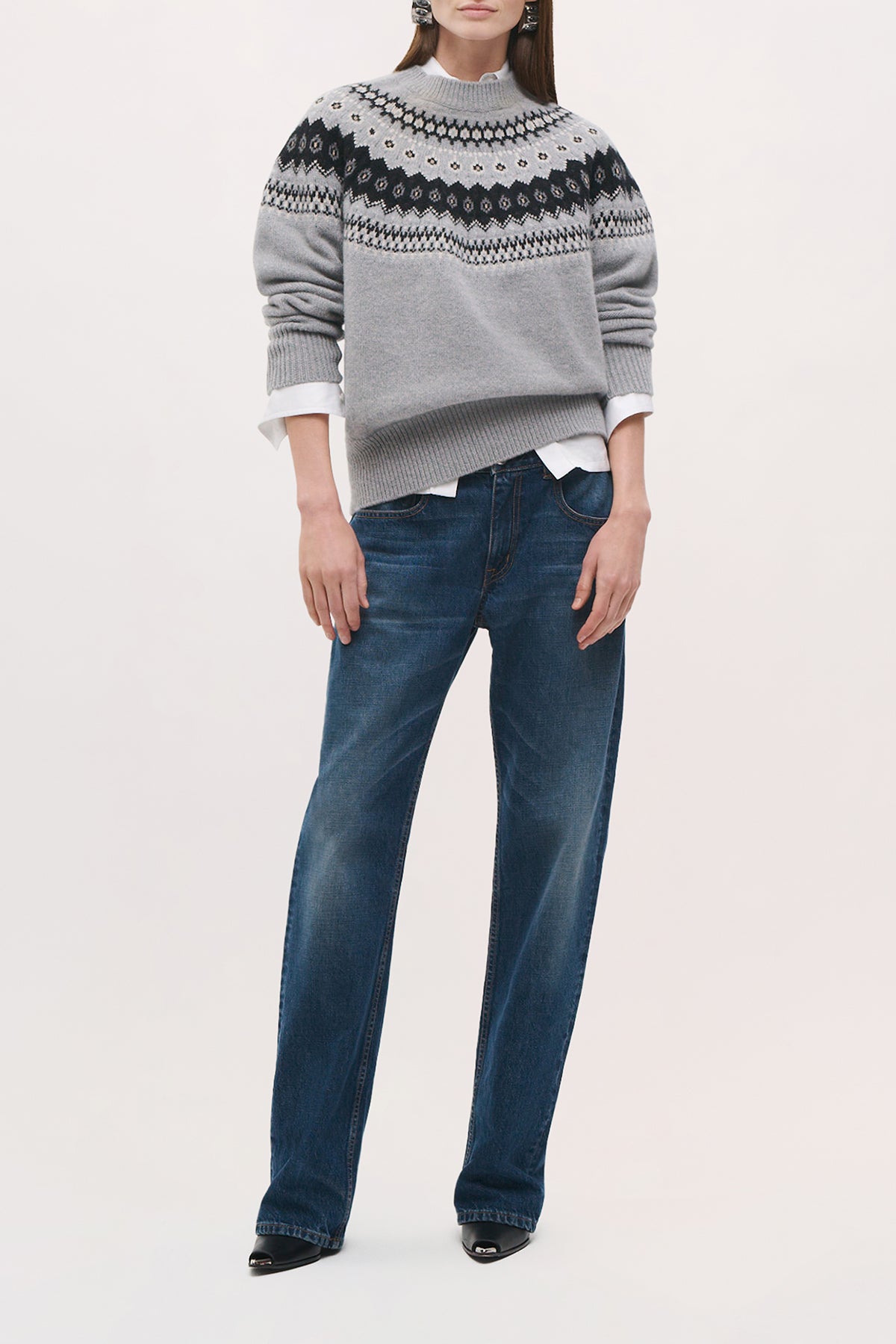 Front view of a model wearing the Joanna Sweater in Fair Isle, a relaxed-fit crewneck sweater with dropped shoulders, long sleeves, and a black-and-white patterned yoke.