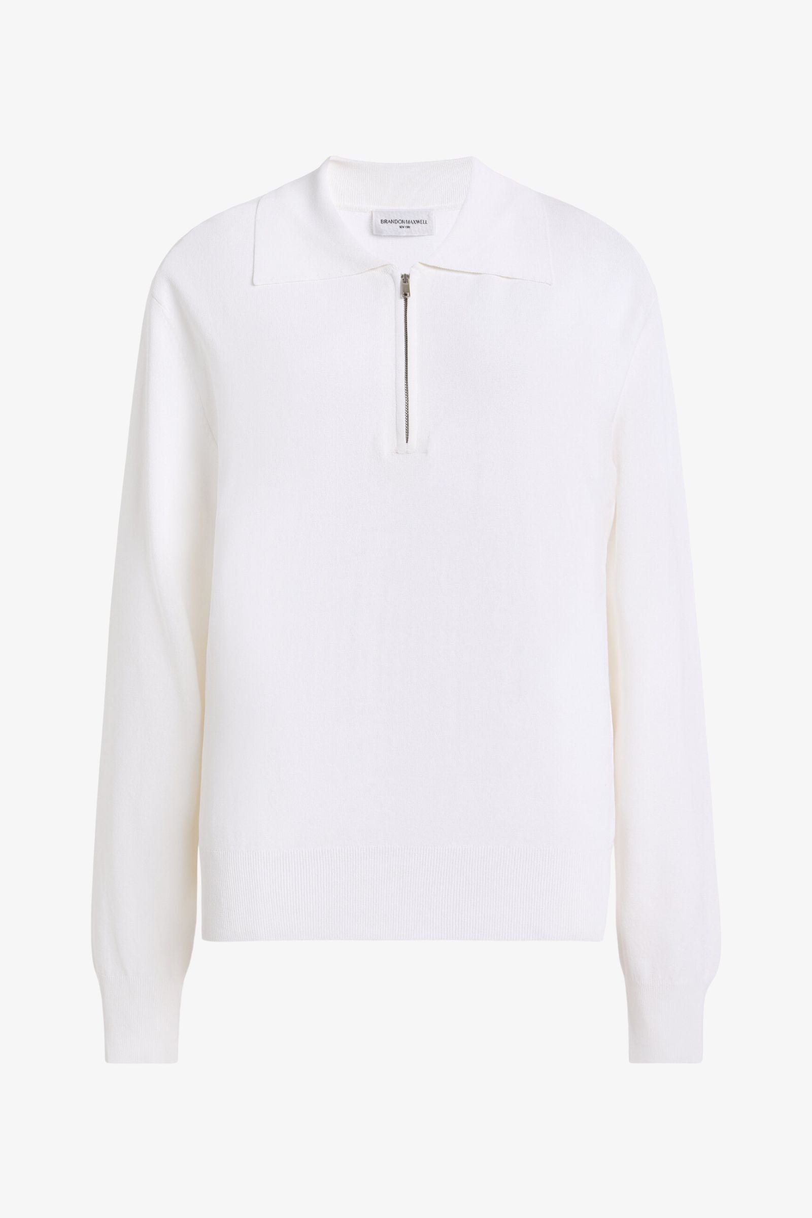 A white long-sleeve knit top with a mock neck and a short center zipper, shown on a clean white background.