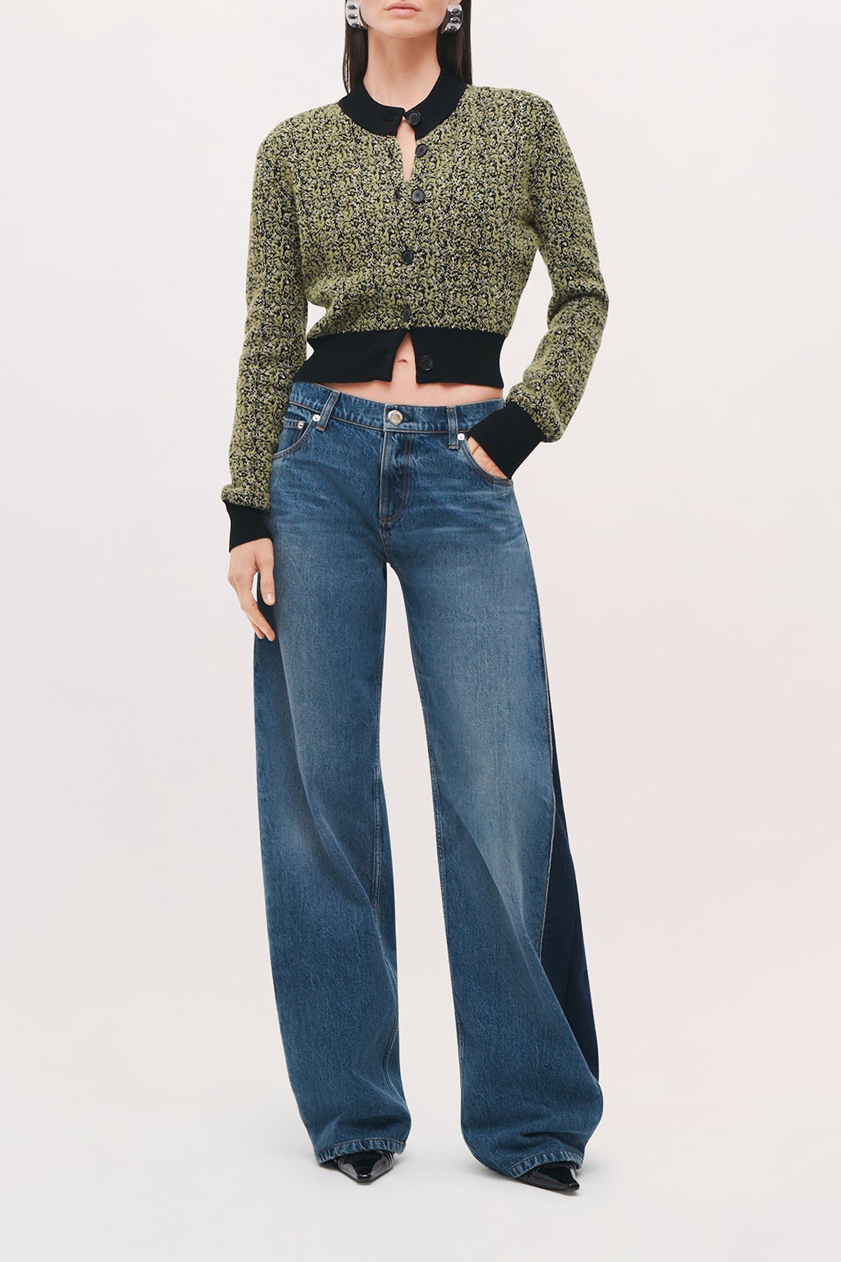 Front view of a model wearing the Lana Trousers in Bi-Color Wash, wide-leg jeans with contrasting darker denim panels along the sides