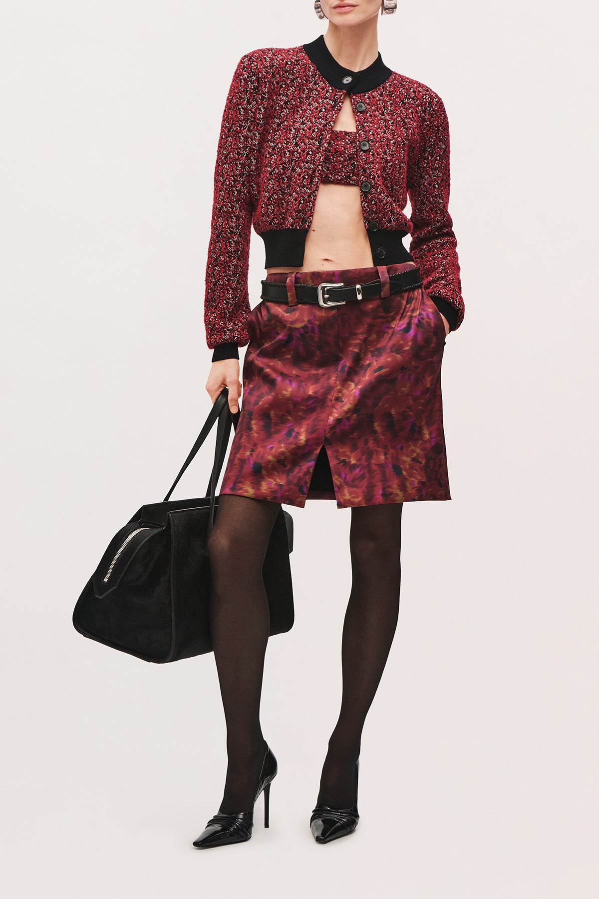 Angled front view of a model wearing the Demi Bandeau in Red Static, a strapless cropped top with a textured red-and-black knit.