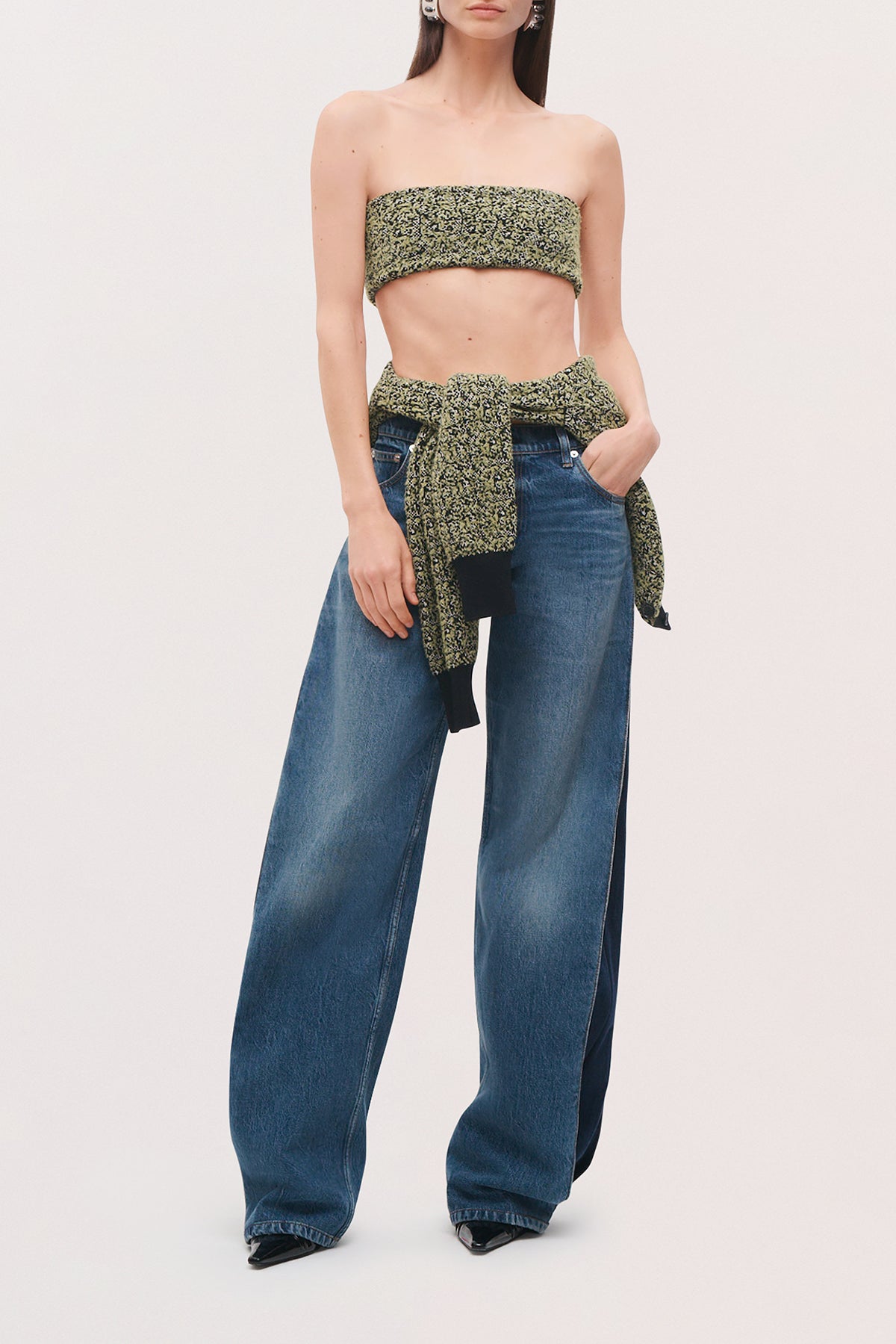 Front view of a model wearing the Demi Bandeau in Green Static, a strapless cropped top with a green-and-black pattern.