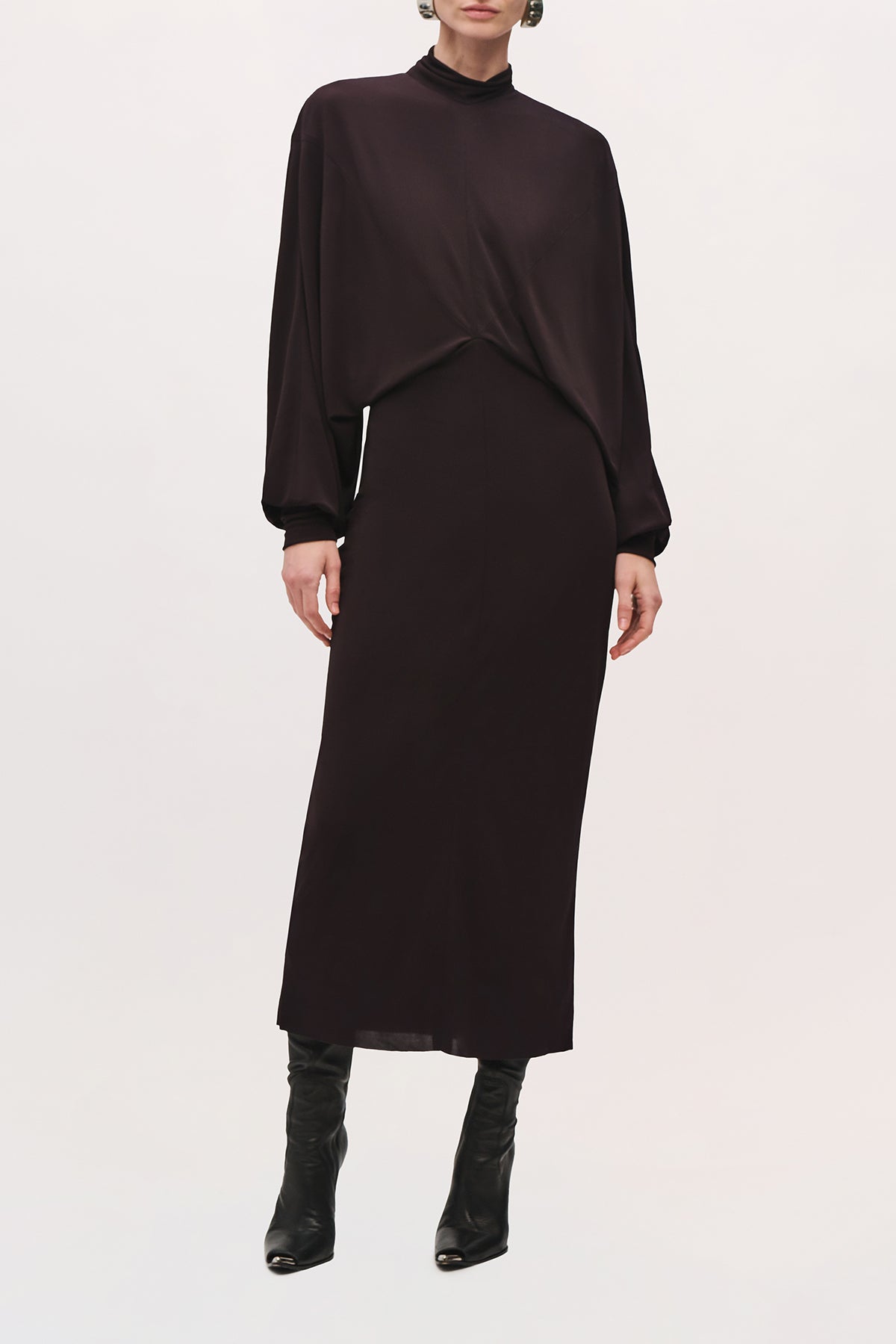 Front view of a model wearing the Helena Dress in Ganache, a long-sleeve midi dress with a draped bodice and fitted skirt