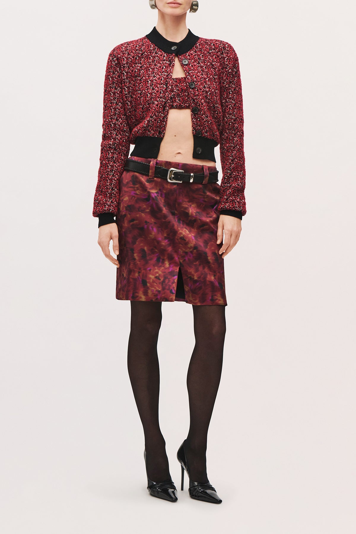 Full body front view of a model wearing the Lex Pencil Skirt in Red Floral, a fitted high-waisted skirt, midi-length skirt, and front slit. 