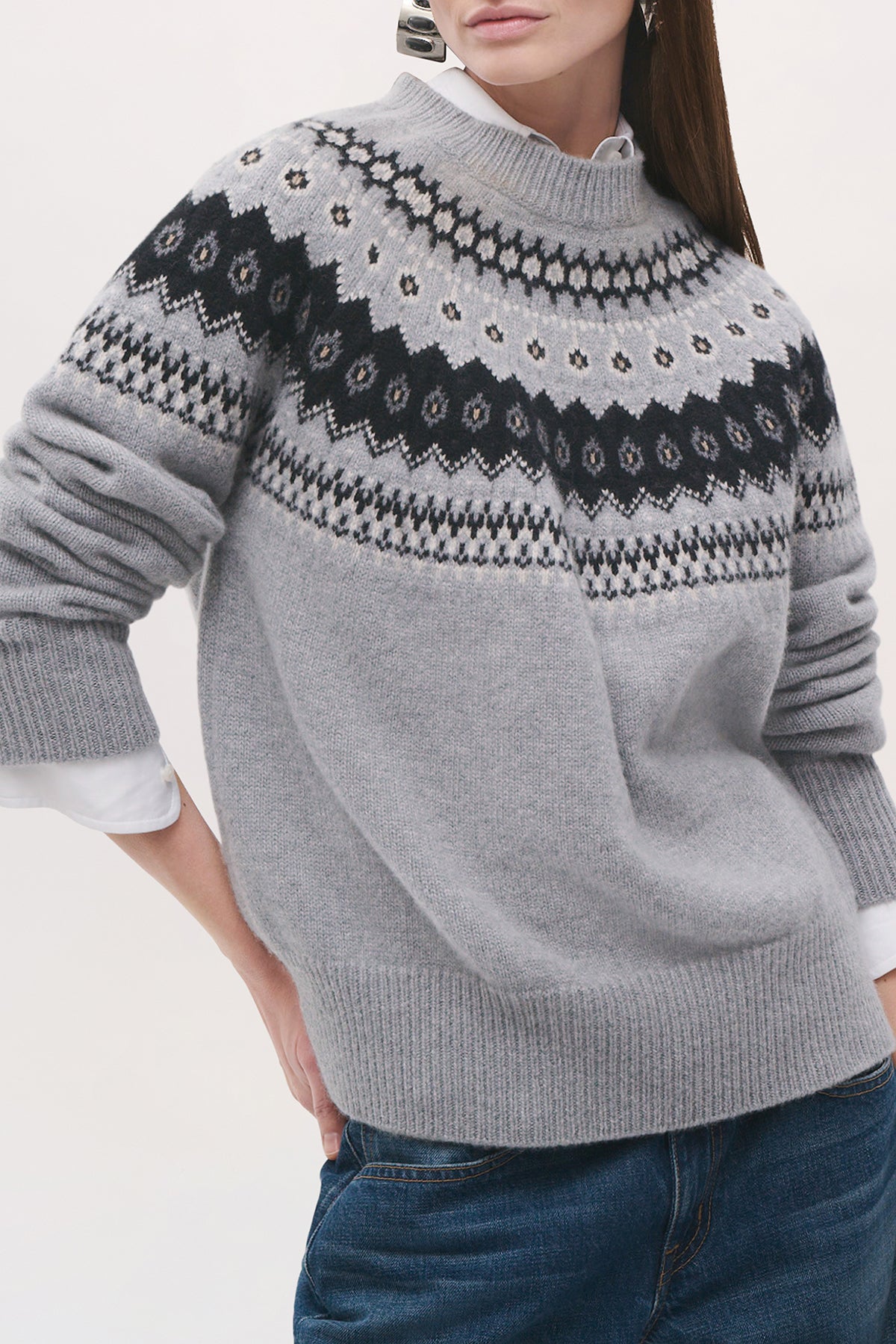 Close-up front view of a model wearing the Joanna Sweater in Fair Isle, highlighting its relaxed fit, ribbed crew neckline, and black-and-white patterned yoke.