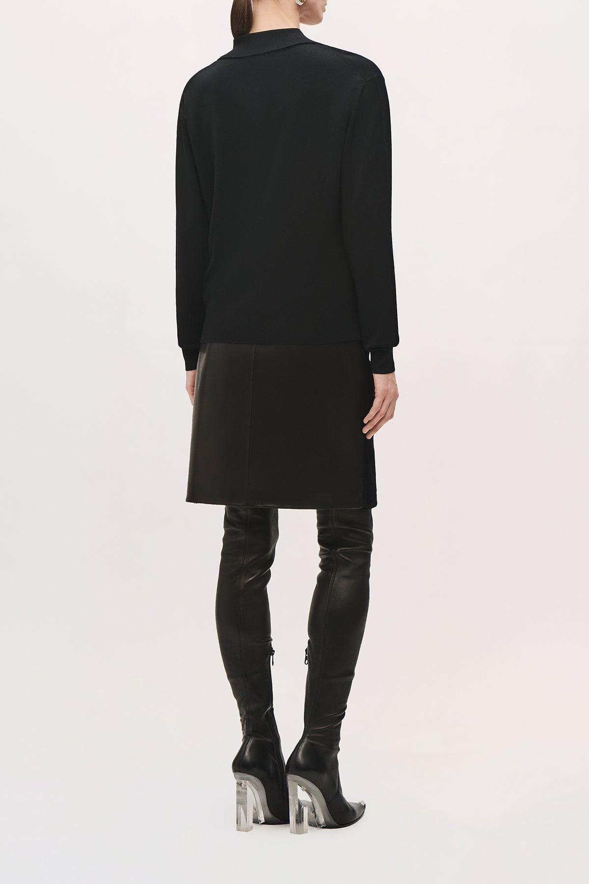 Back view of a model wearing the Keaton Sweater in Black, showing its slim fit, straight hem, and long sleeves.