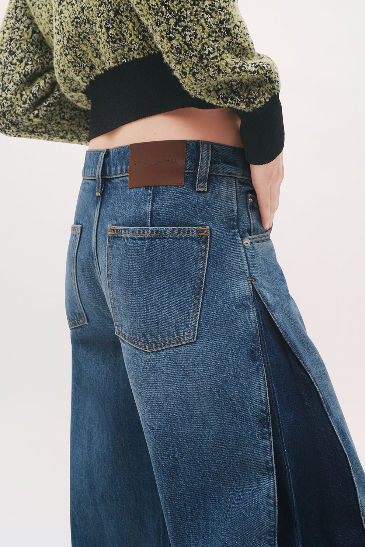 Close-up back view of the Lana Trousers in Bi-Color Wash, showing the back pockets, leather logo patch, and contrasting side panels.