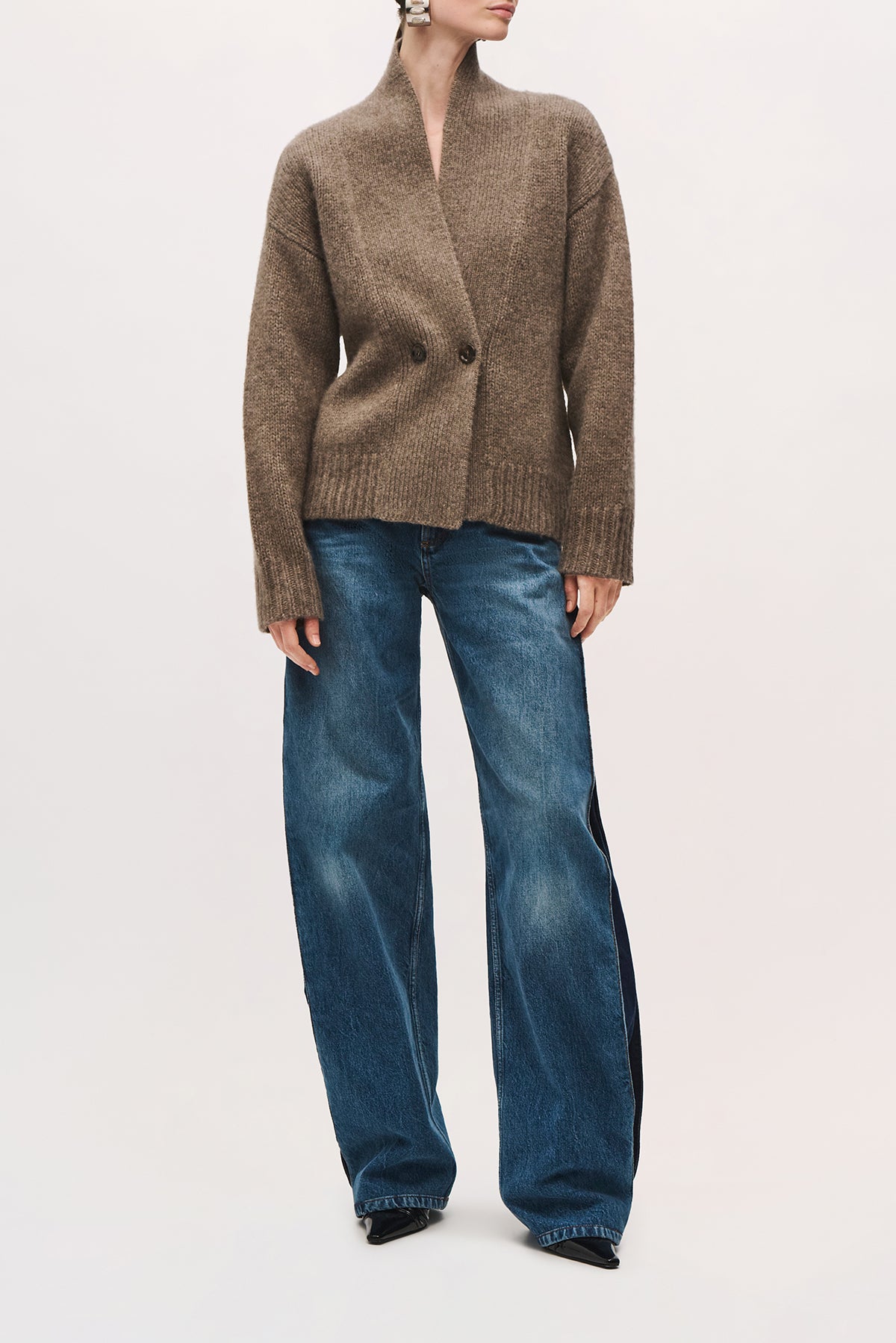 Front view of a model wearing the Lowen Cardigan in Truffle, with a double-breasted button closure and a loose fit below the hips.