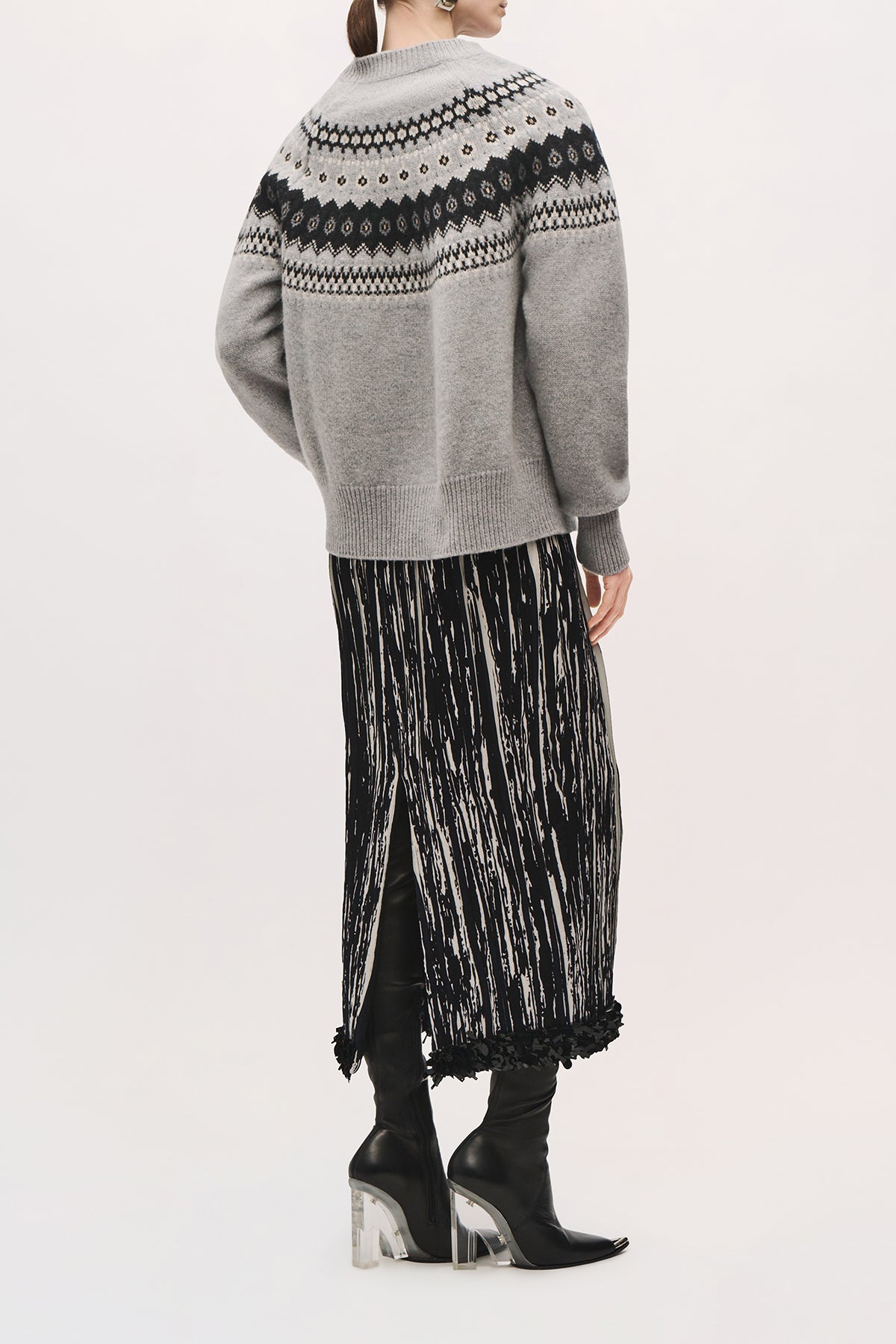 Back view of a model wearing the Sinclair Skirt in Black/White, showing its straight silhouette, back slit, and black sequin hem.