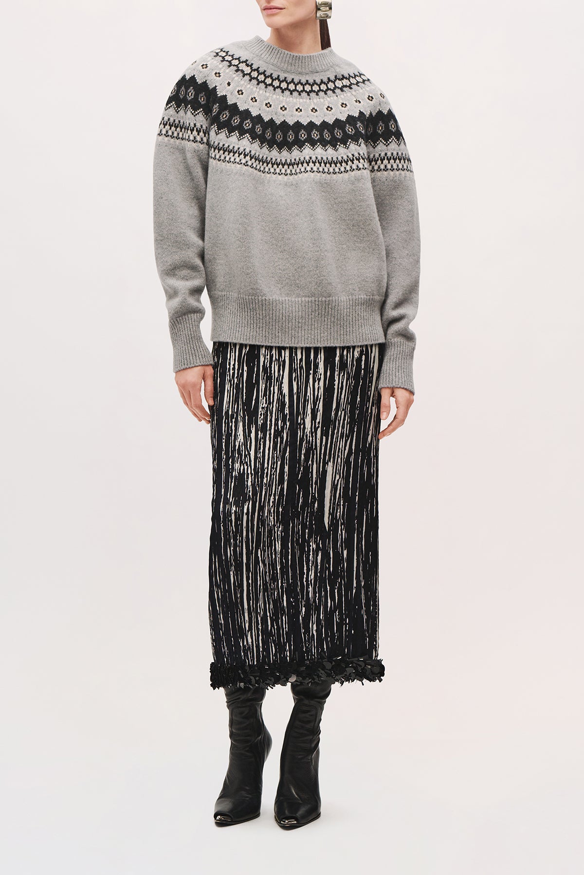 Front view of a model wearing the Sinclair Skirt in Black/White, a midi-length skirt with a straight silhouette and black sequin hem.
